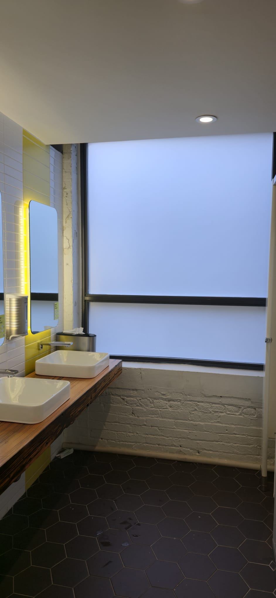 Commercial washroom with large frosted privacy window