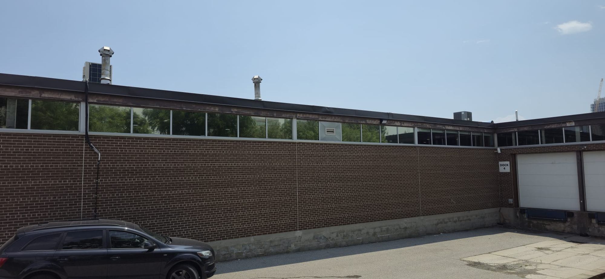 Brick commercial building with solar film on upper ribbon windows