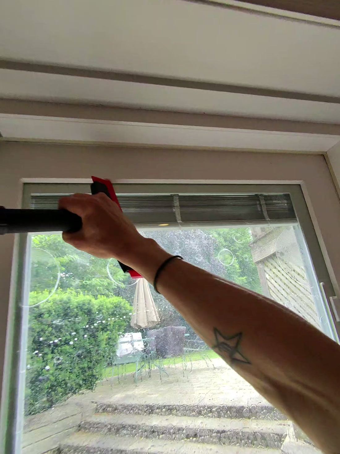 Squeegeeing the film flat from top to bottom