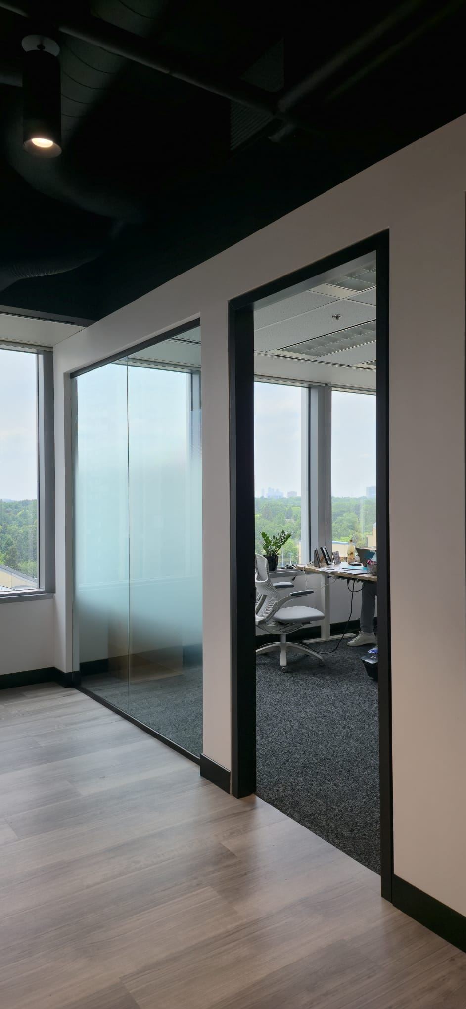 Office hallway with frosted privacy film on glass partitions